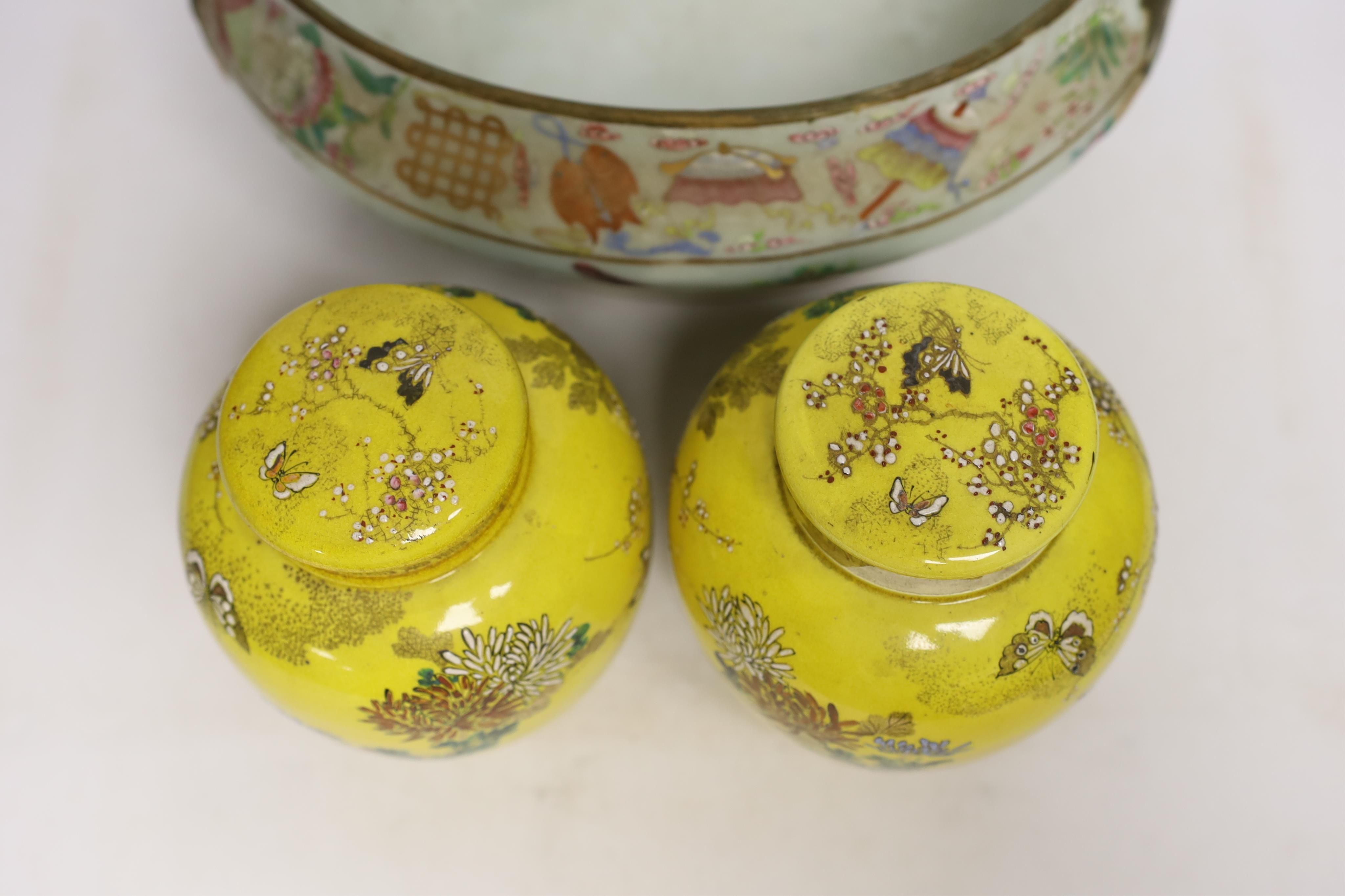 A 19th century Chinese famille rose tureen (lacking cover), a bronze mirror, a brush pot, a crackle glazed teabowl and a pair of Japanese yellow glazed satsuma jars and covers, tallest 18cm (6)